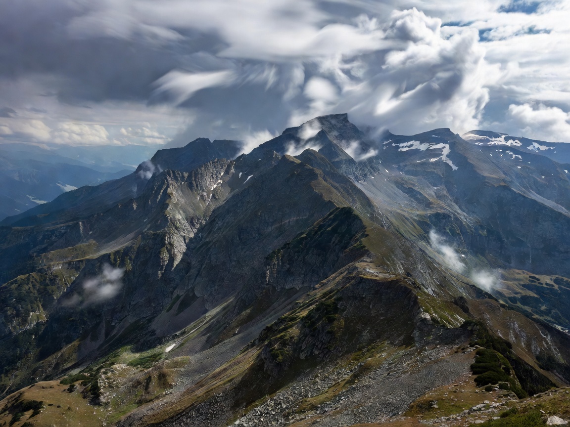 Alpine mountain ridge showing deep valleys and weather conditions